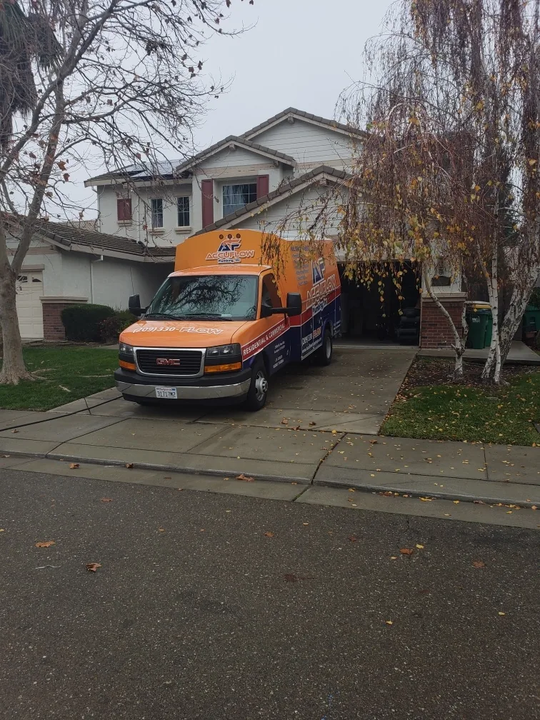 AccuFlow Plumbing truck at a customer's home