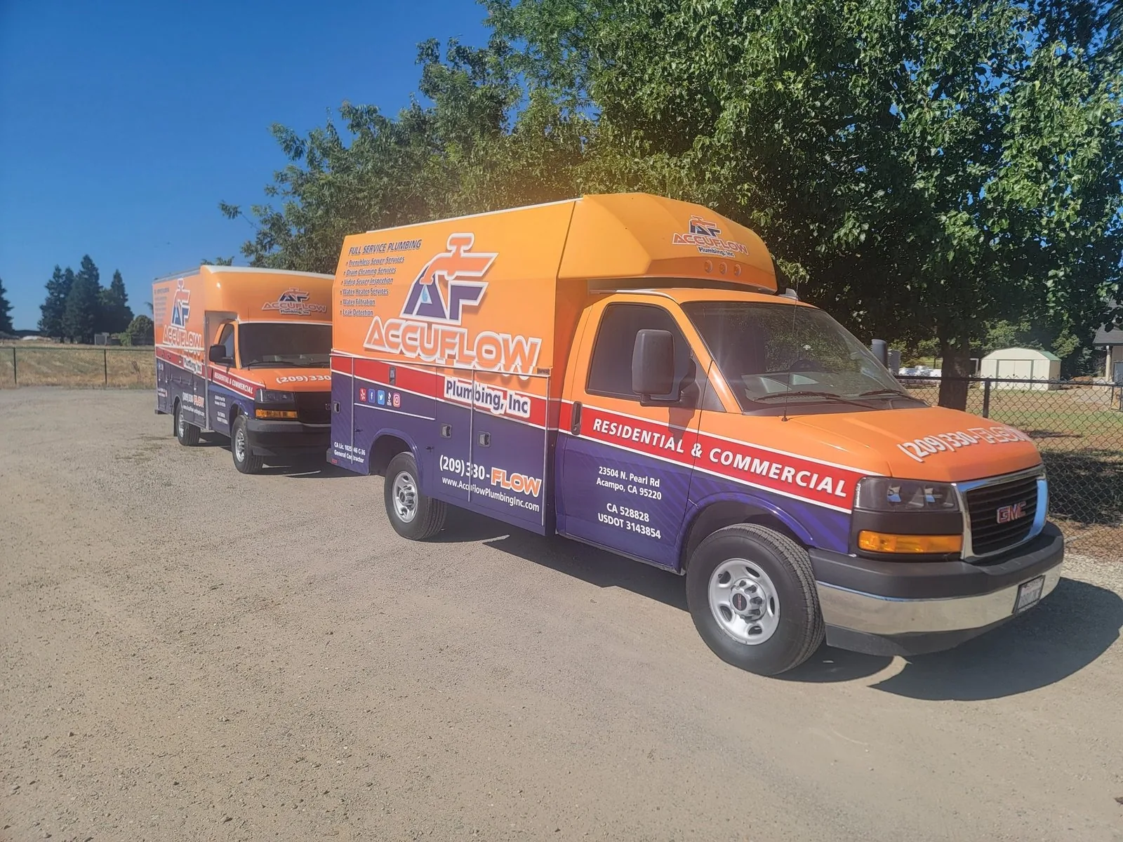 AccuFlow Plumbing service trucks parked on site